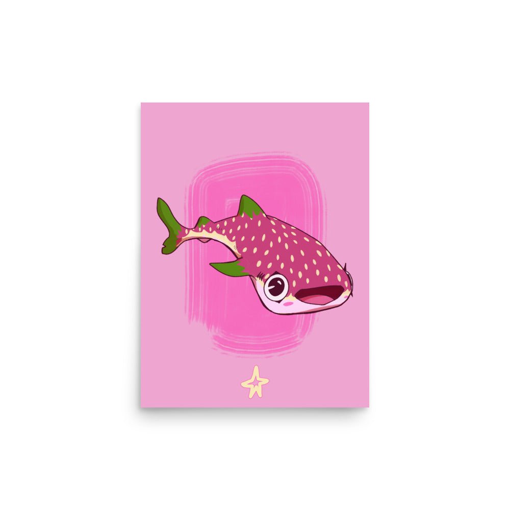 Framed artwork of a fish on a pink background on a wooden cabinet.