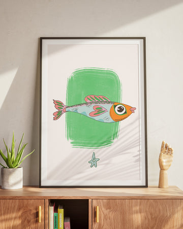 Framed artwork of a colorful fish on a wall above a wooden cabinet.