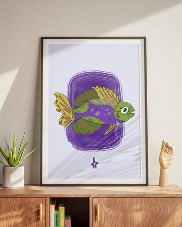 Framed artwork of a green fish on a purple background, displayed on a wooden cabinet.